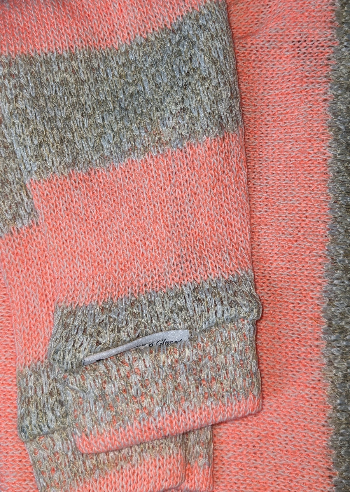 Coral and tan striped Italian Greyhound sweater, folded close-up of the sleeve and label