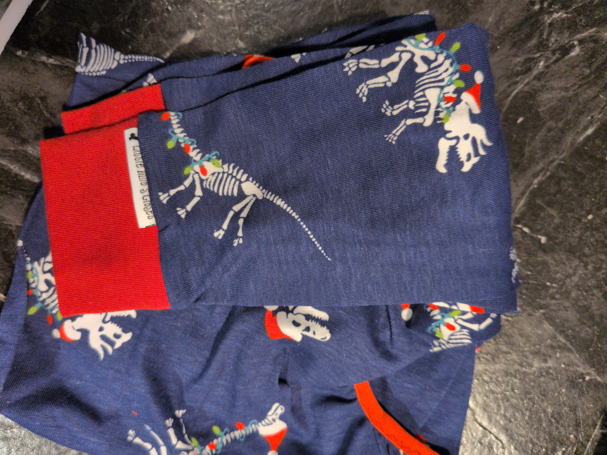Folded navy Christmas bodysuit with dinosaur skeletons in Santa hats and lights, plus a red cuff