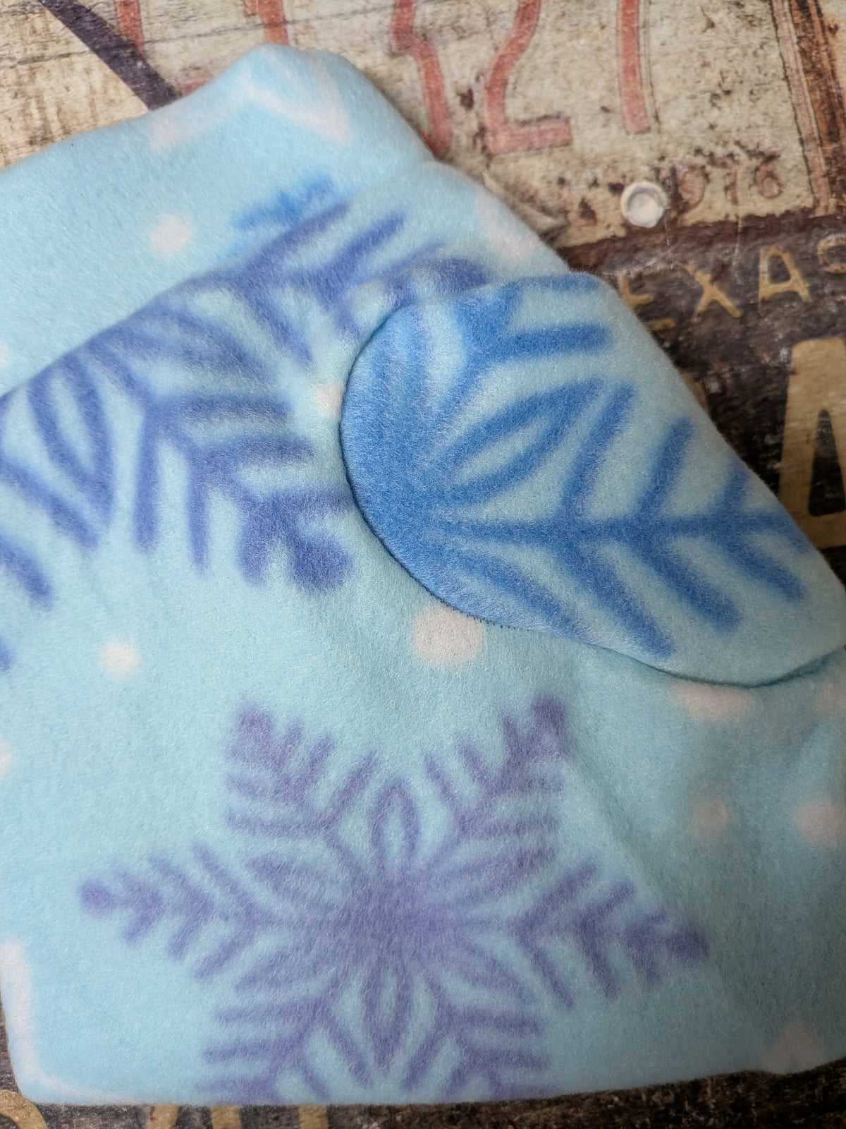 Snowflakes on Blue Christmas fleece top, light blue fleece with blue and lavender snowflakes, close-up