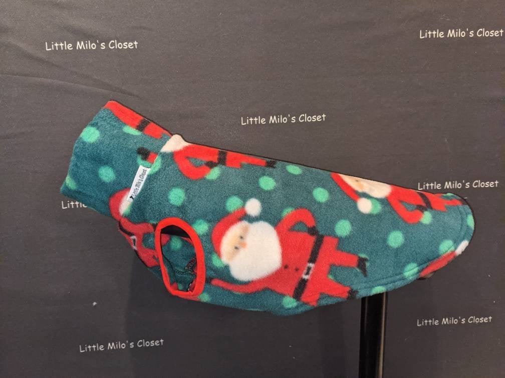 Teal Christmas fleece vest with Santa and green polka dots for Italian Greyhounds on a stand