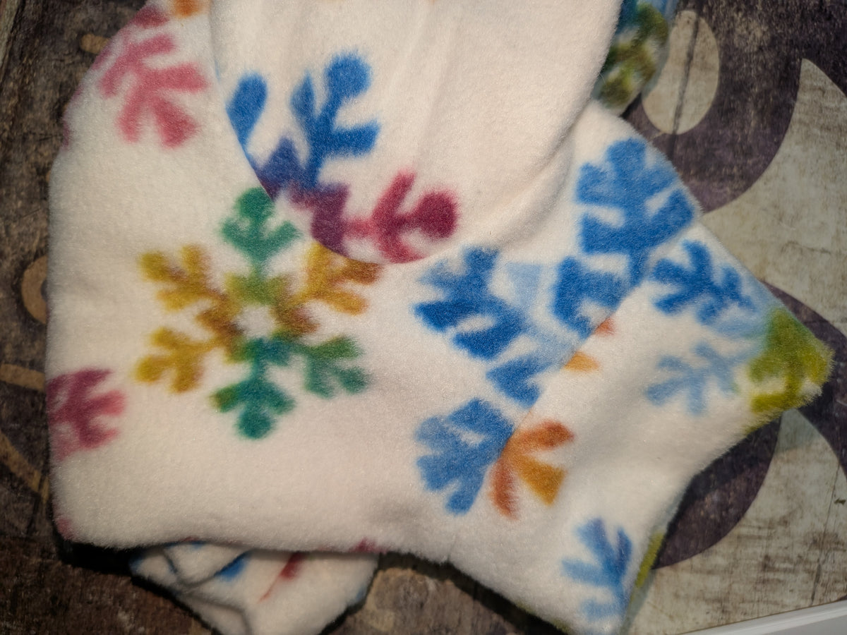 Close-up of white Pastel Snowflake fleece jammies for Italian Greyhounds with rainbow colored snowflakes