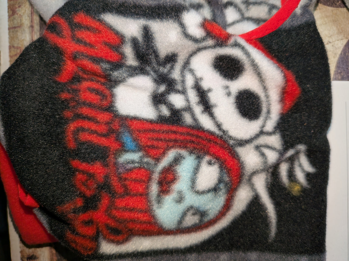 Close-up of black Nightmare Before Christmas fleece jammies with skeleton and rag doll characters