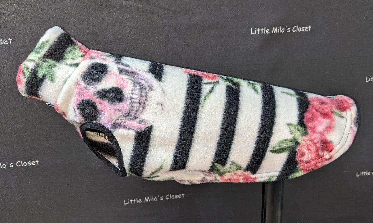 Halloween fleece vest with black and white stripes, skulls and pink roses, on a dog form