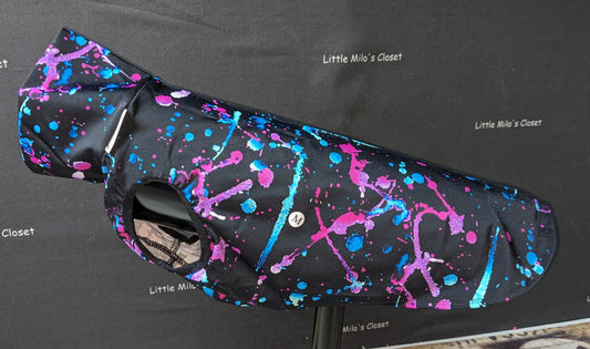 Paint Splatter large UV turtleneck vest, black with neon pink and blue splatter, on a dog form