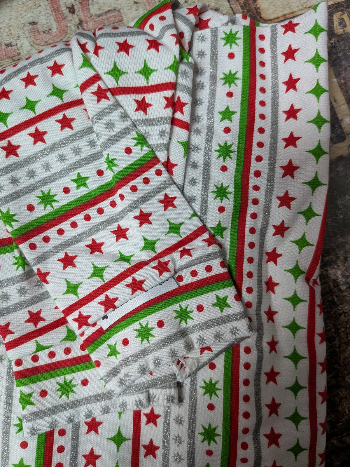 Christmas two legged Italian Greyhound top in white with red, green and silver stripes and stars, folded flat
