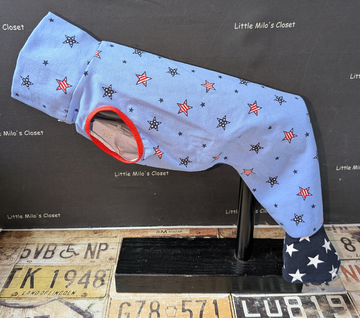 Light blue patriotic stars bell bottom bodysuit with red and navy stars and navy star print bell cuffs, on a dog form