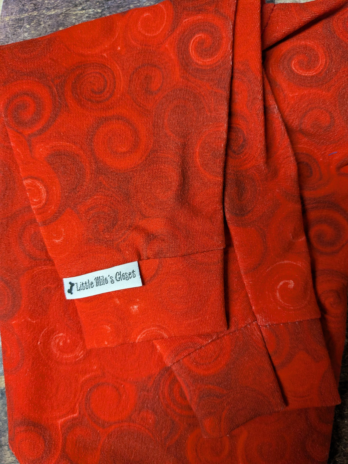 Red Swirl two legged Italian Greyhound top in red tone on tone swirl fabric, folded with a Little Milo's Closet label