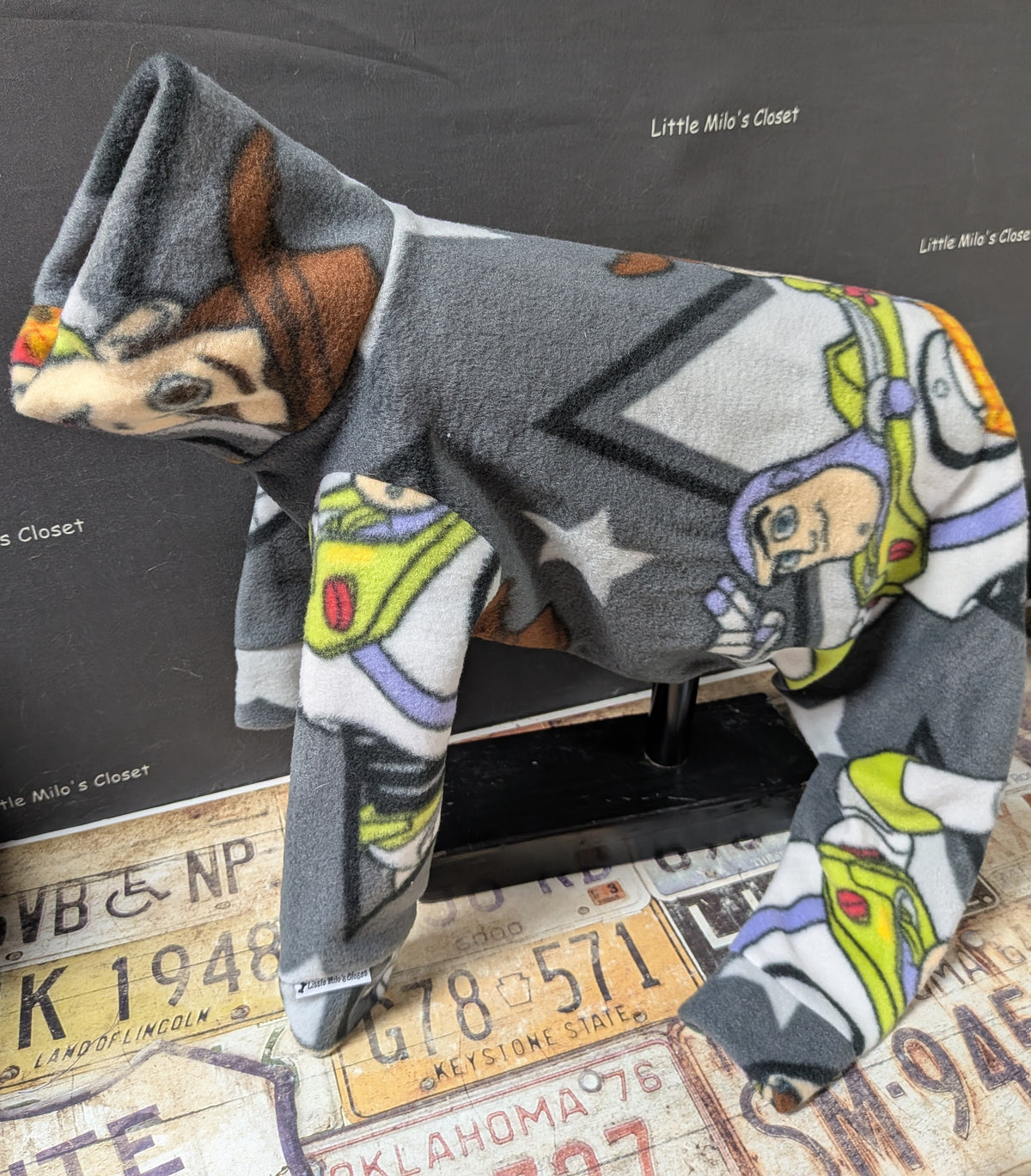 Grey Toy Story fleece bodysuit with Woody and Buzz Lightyear, side view on an Italian Greyhound dog form