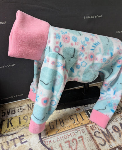 Aqua fleece bodysuit with pastel whales and flowers, pink neck and cuffs, side view on a dog form
