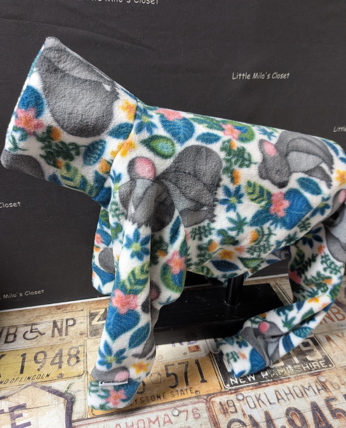 Koala fleece bodysuit with grey koalas and green leaves on white, side view on an Italian Greyhound dog form
