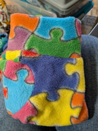 Folded puzzle piece fleece Italian Greyhound bodysuit in bright blue, yellow, green and pink