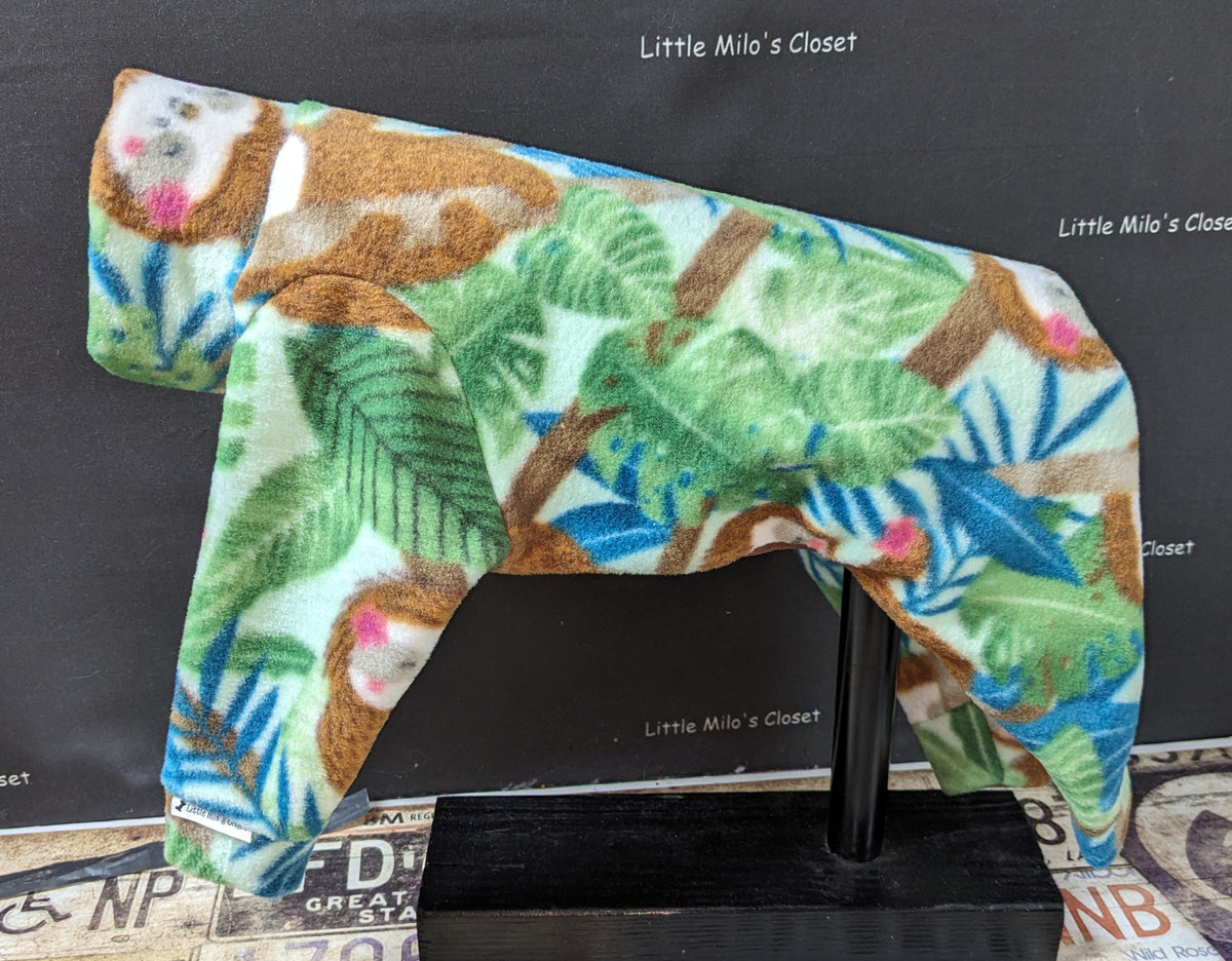 Light green fleece bodysuit with sloths hanging among tropical leaves, side view on a dog form