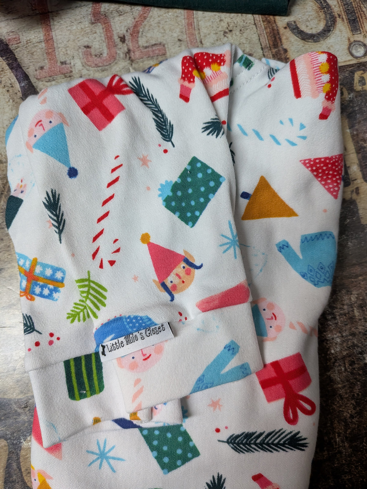 Folded white Tossed Elves two legged Christmas top for Italian Greyhounds with elves, gifts and candy canes