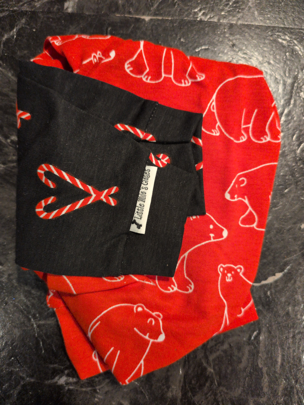 Folded red polar bear print Christmas bodysuit with a black candy cane print collar and sleeves