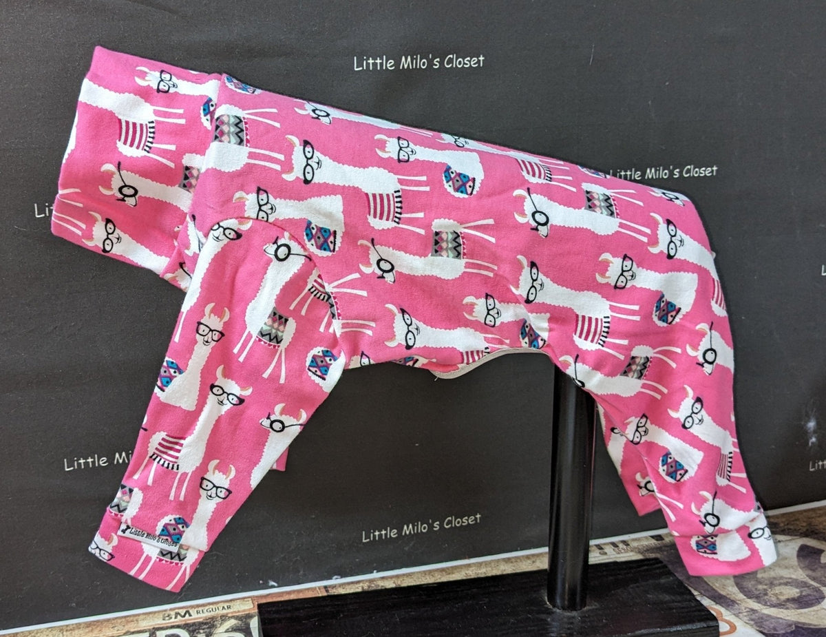 Pink Holiday Llamas Italian Greyhound bodysuit on a display form, white llamas on a pink cotton lycra print