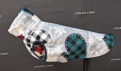 Grey Christmas fleece vest with teal buffalo check mittens and snowflakes on a display stand