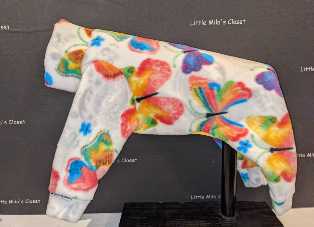 White plush fleece Italian Greyhound bodysuit with rainbow butterflies and hearts, side view on a form