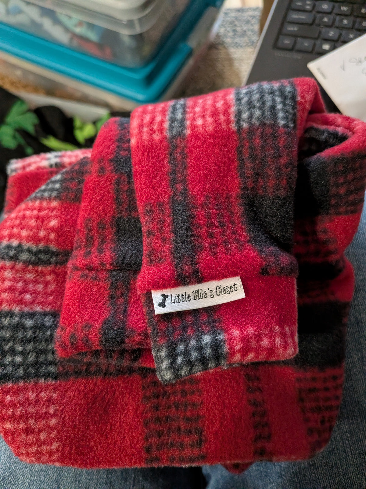 Folded red and black plaid plush fleece Italian Greyhound bodysuit with the brand label on the cuff