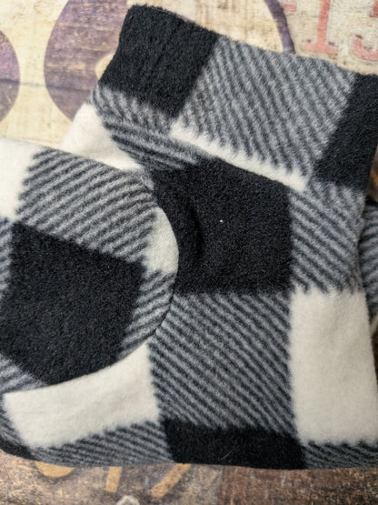 Folded black, white and grey buffalo check plush fleece bodysuit for an extra small Italian Greyhound
