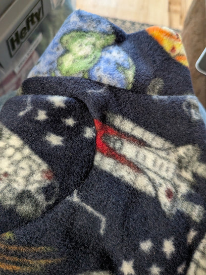 Folded navy outer space plush fleece bodysuit with stars and planets, extra small Italian Greyhound size