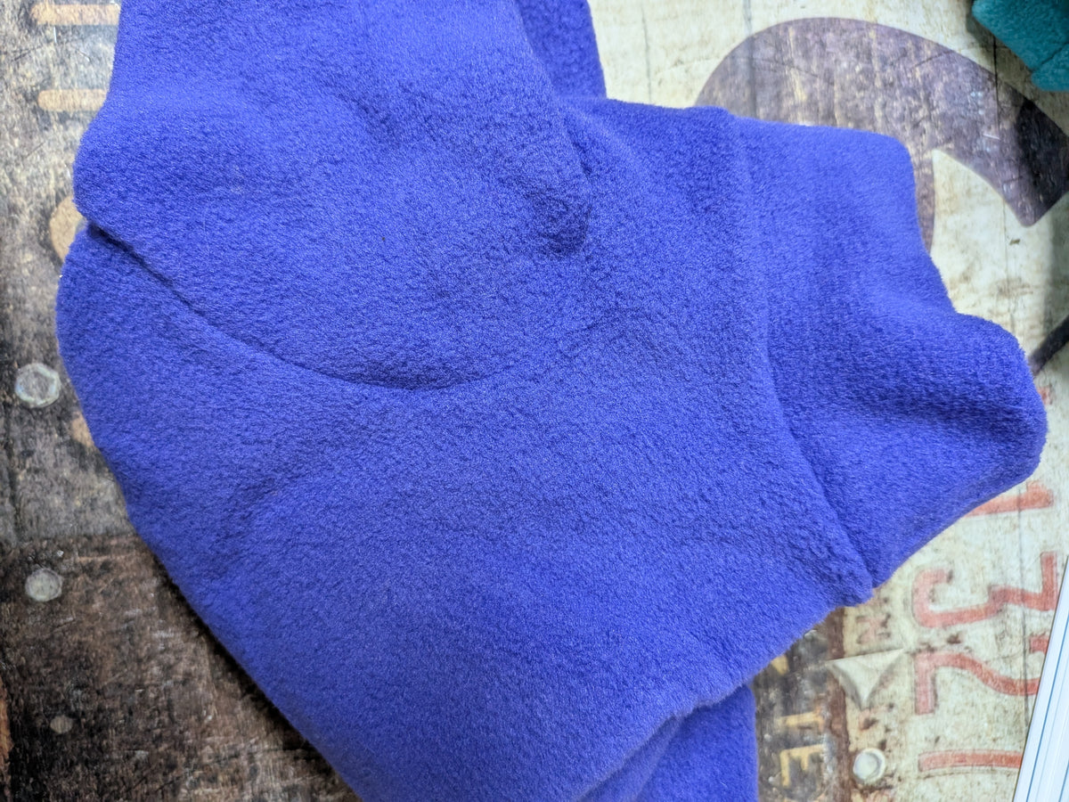 Folded solid royal blue plush fleece bodysuit for an extra small Italian Greyhound