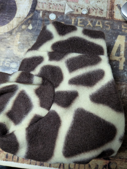 Folded brown and cream giraffe print plush fleece bodysuit for an extra small Italian Greyhound