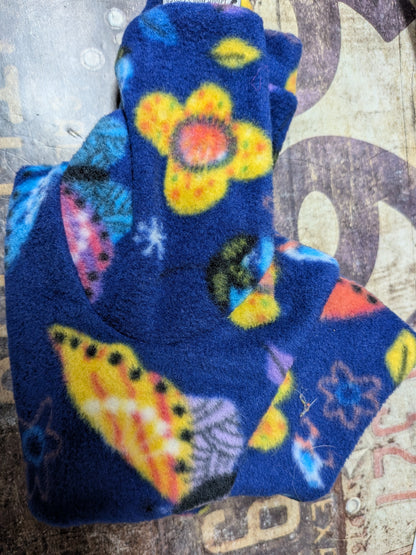 Folded royal blue plush fleece Italian Greyhound bodysuit with yellow flowers and colorful leaves