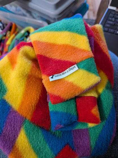 Folded rainbow striped plush fleece Italian Greyhound bodysuit with brand label on the cuff