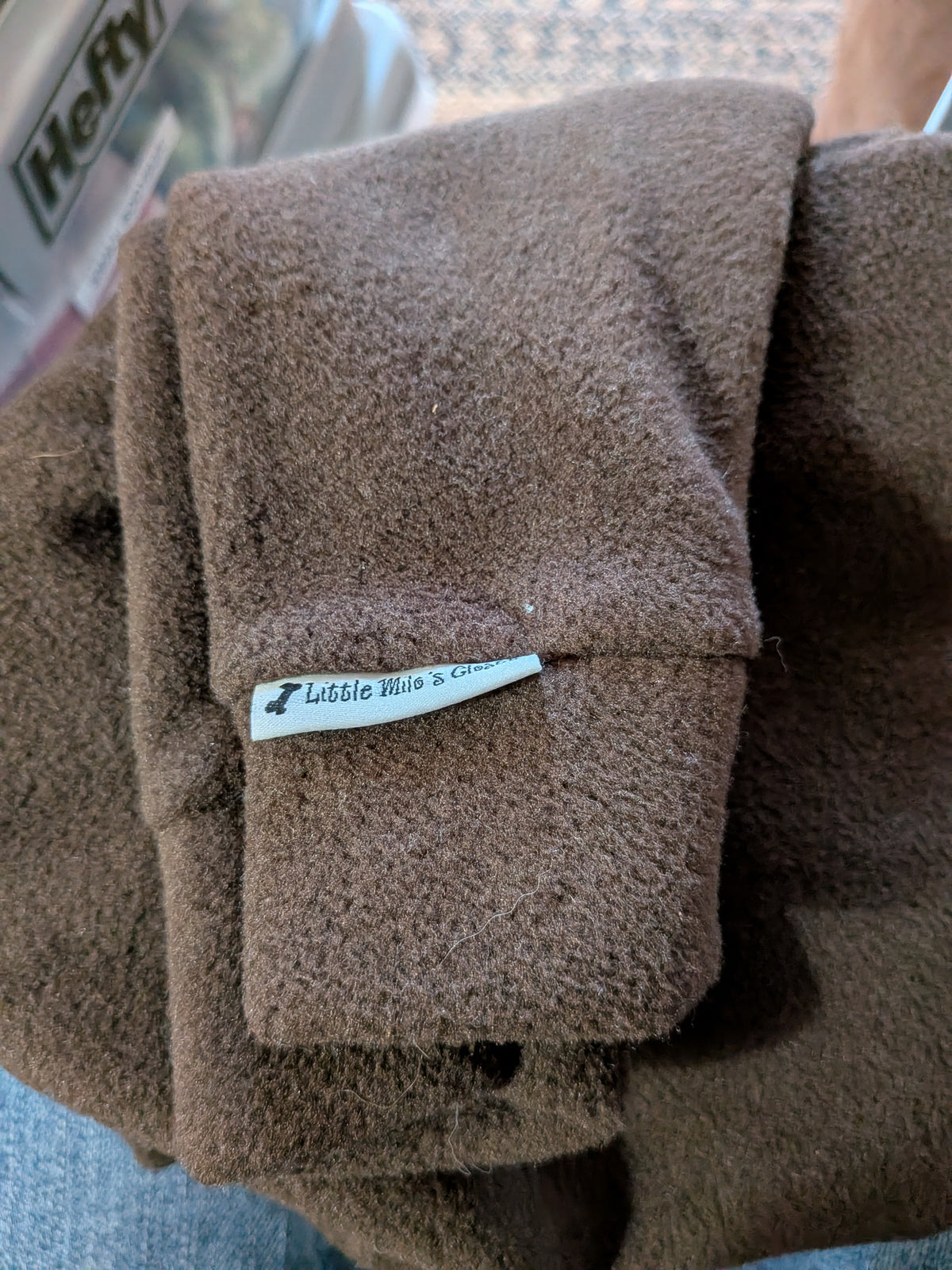Folded solid chocolate brown plush fleece bodysuit with brand label, extra small Italian Greyhound size