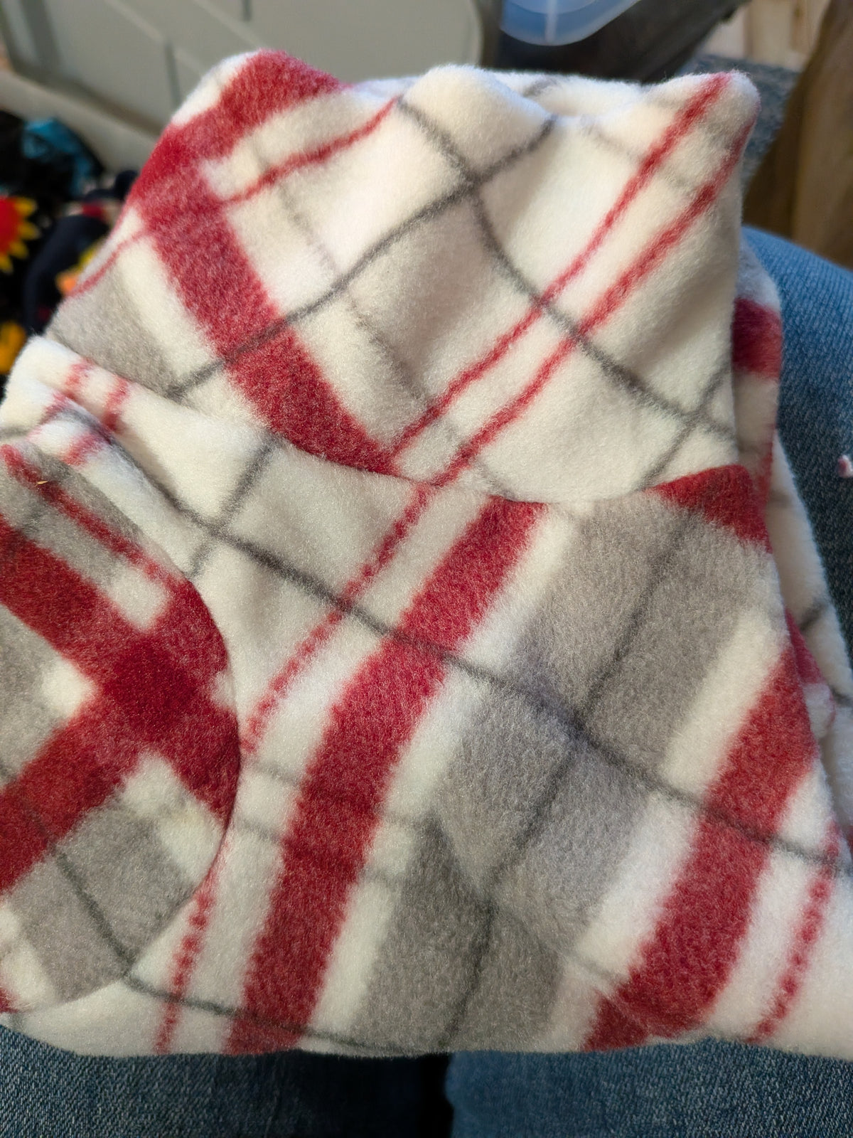 Folded cream plush fleece bodysuit with red and grey plaid, extra small Italian Greyhound size