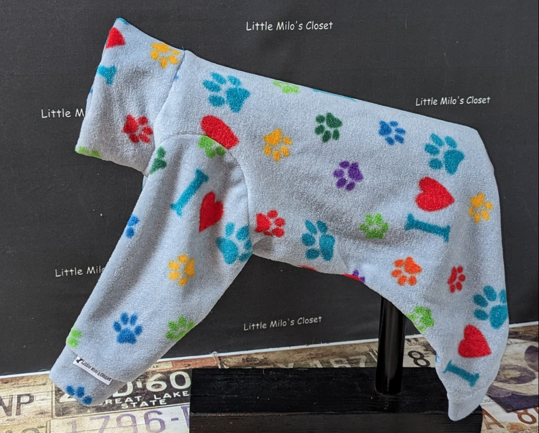 Light blue plush fleece Italian Greyhound bodysuit with colorful paw prints, red hearts and bones