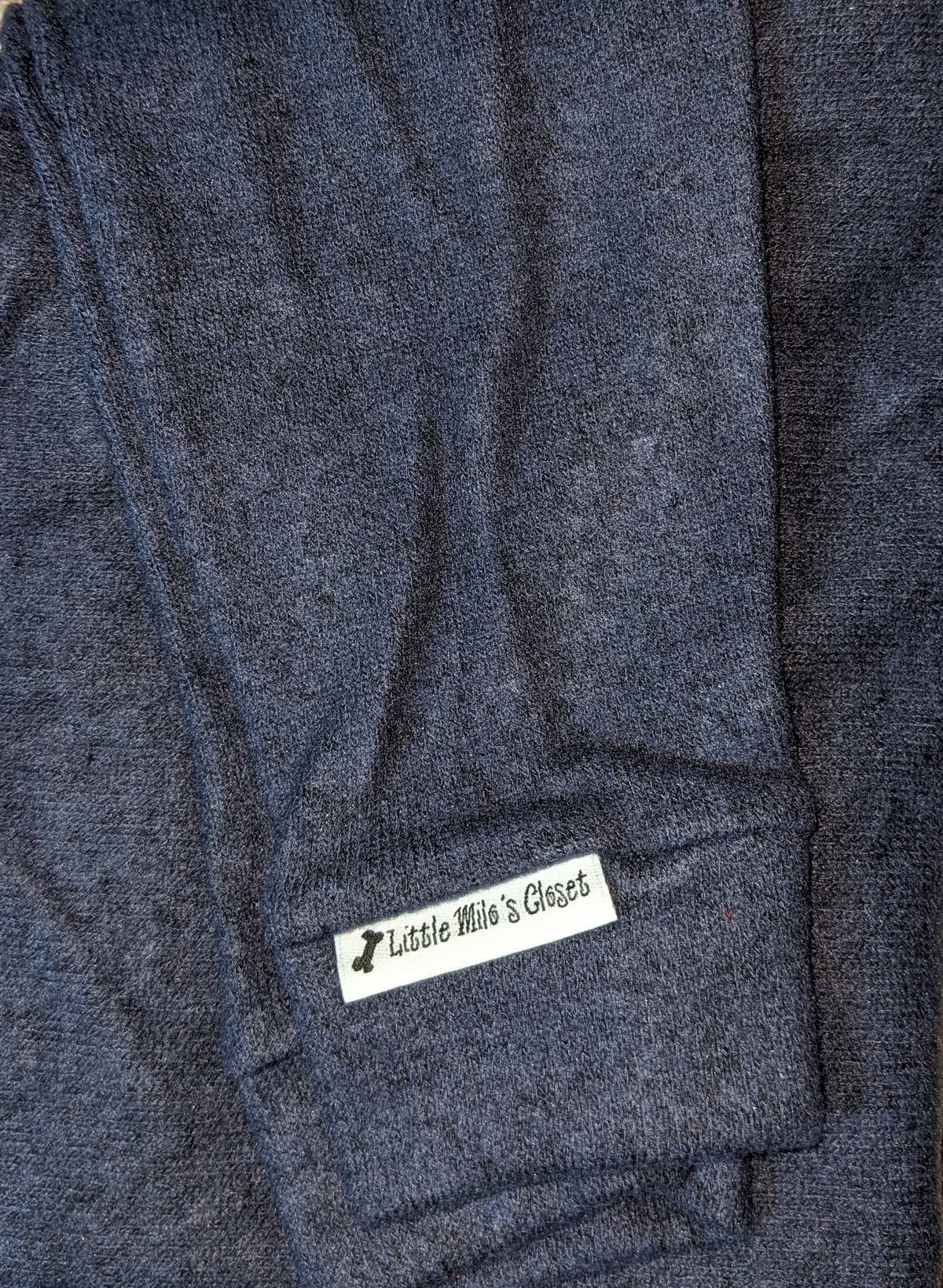 Navy hacci knit Italian Greyhound sweater folded flat with ribbed cuff and label