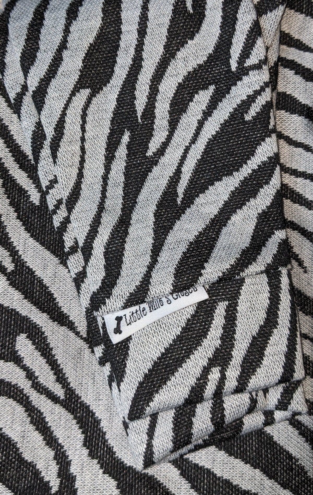 Zebra print hacci knit Italian Greyhound sweater in black and cream, folded flat