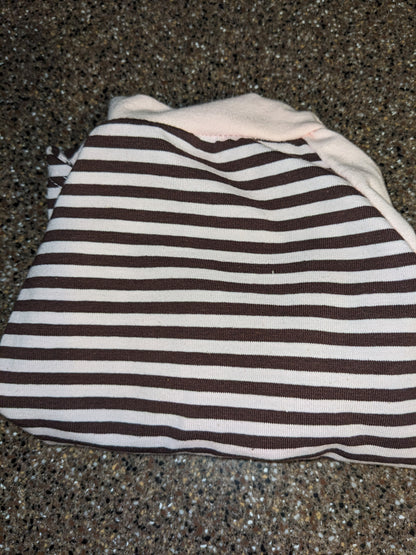 Brown and white striped upcycled dog shirt with a pale pink neckband, folded flat lay