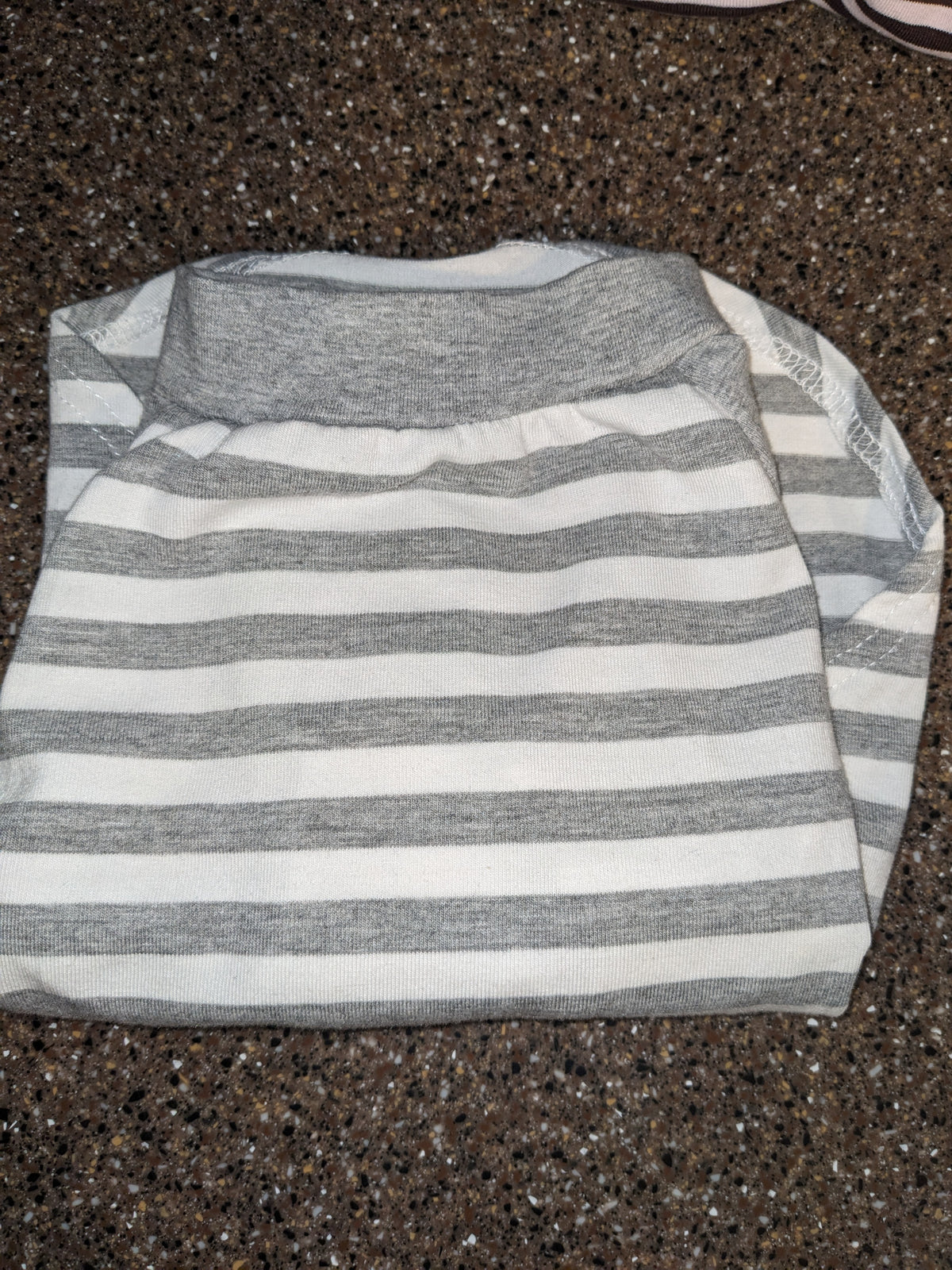 Grey and white striped upcycled shirt for a small Italian Greyhound with a grey neckband, folded flat lay