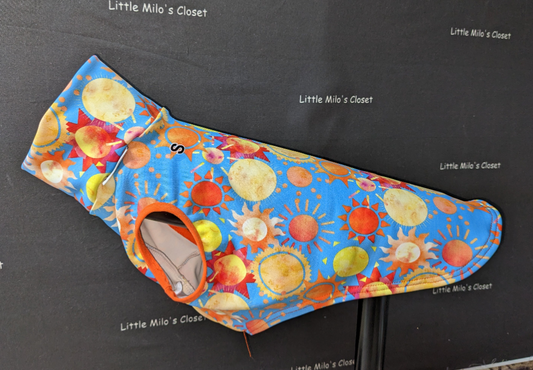 Small UV sleeveless Italian Greyhound vest in bright blue sun print with orange trim, on a dog form