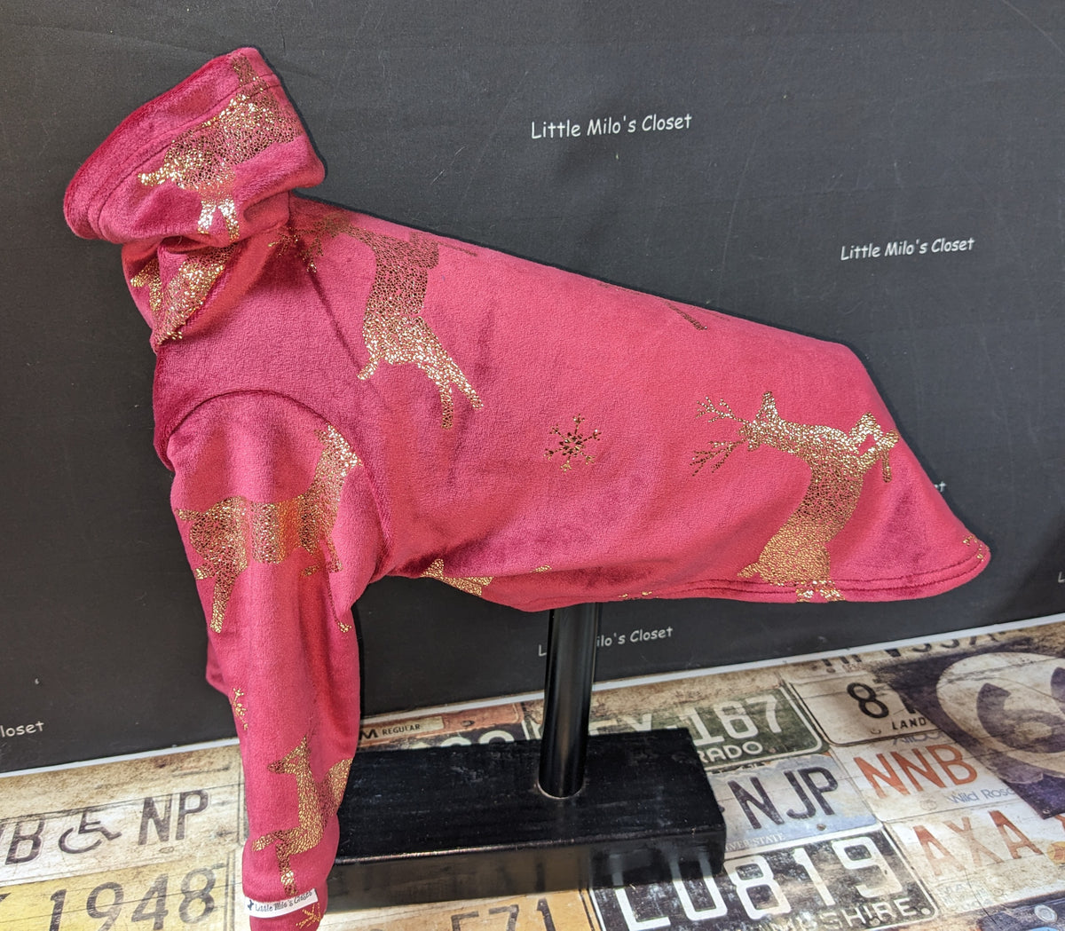 Pink microfleece Italian Greyhound top with gold foil reindeer on a display stand