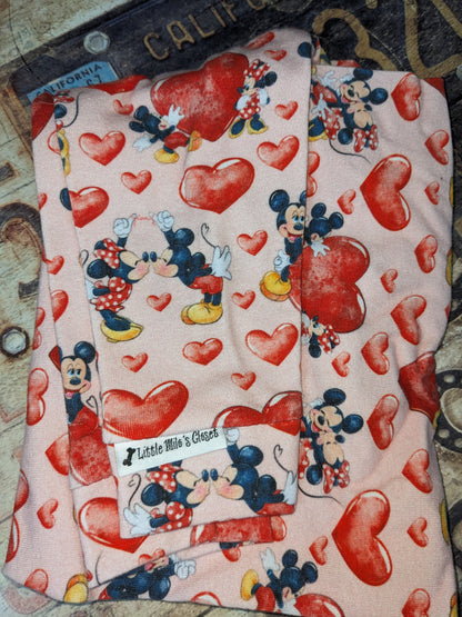 Kissing Mice Valentine's shirt, pink with cartoon mice and red hearts, folded close-up